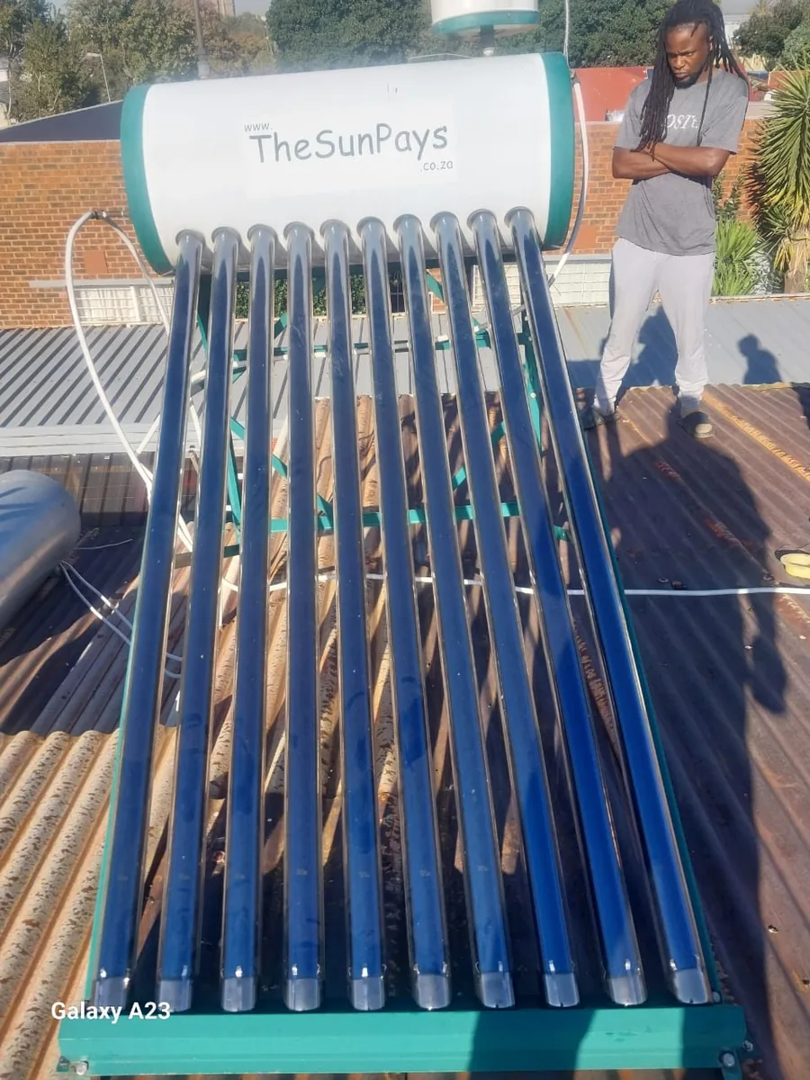 solar geyser plumber inspecting evacuated tubes during a 100 litre solar geyser installation