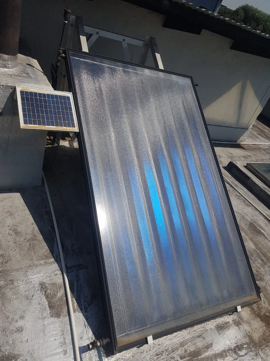 flat plate solar collector inspected for faults and maintenance